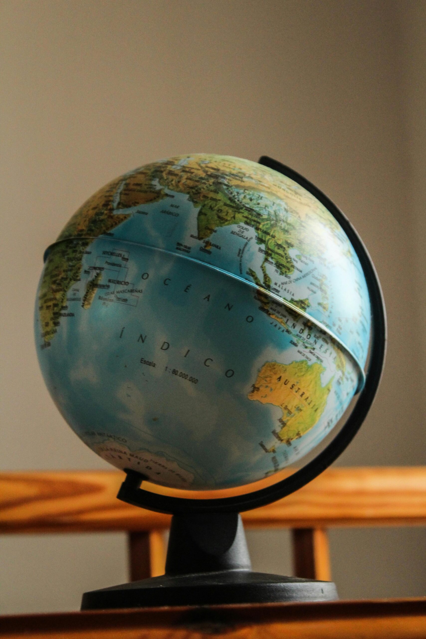 Classic globe displaying continents with a vintage feel on a wooden stand.